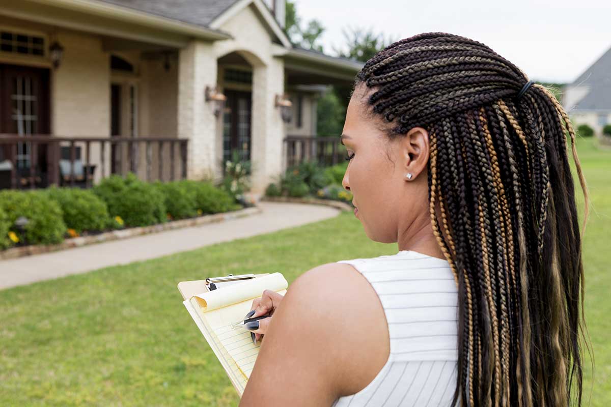 Property agent taking notes on a house claim