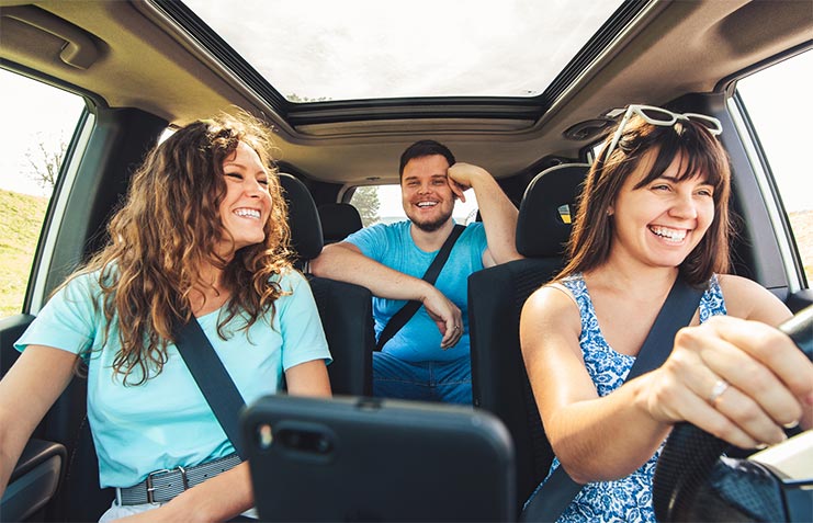 Happy adults driving in car