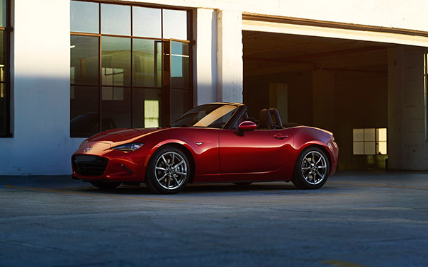 2016 mazda miata in front of a garage