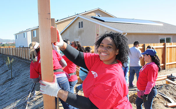 mercury employee putting up a large piece of wood