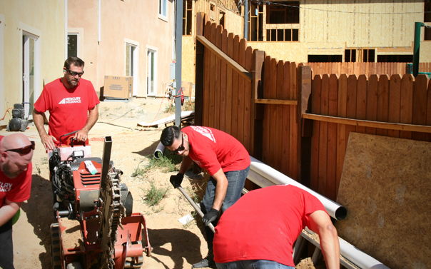 Mercury employees building a fence