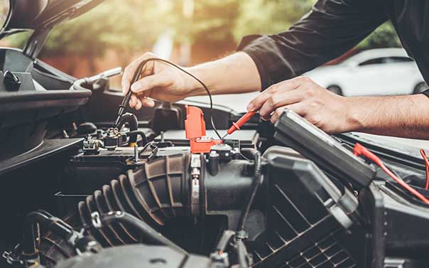 mechanic working on a car battery