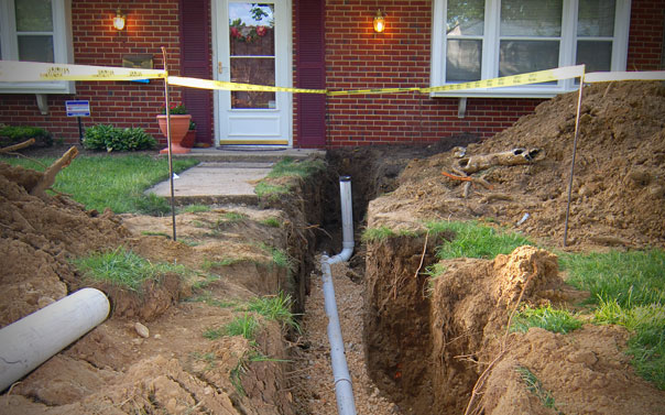 front yard dug up revealing service lines from street to house