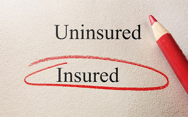 piece of paper and red pencil with the word insured circled in red