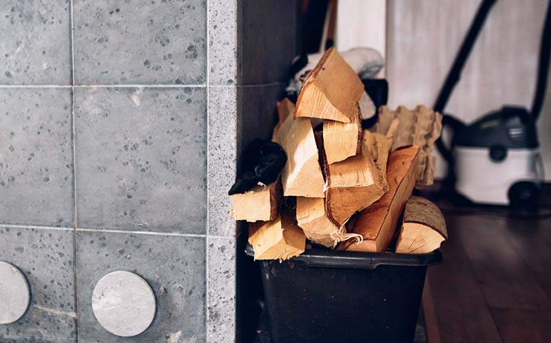 Firewood in bucket inside house