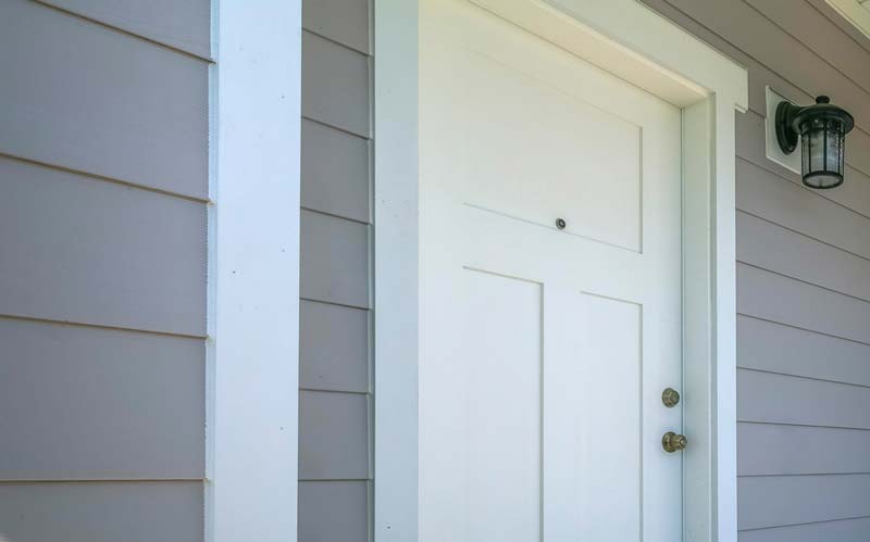 Front door of house with siding