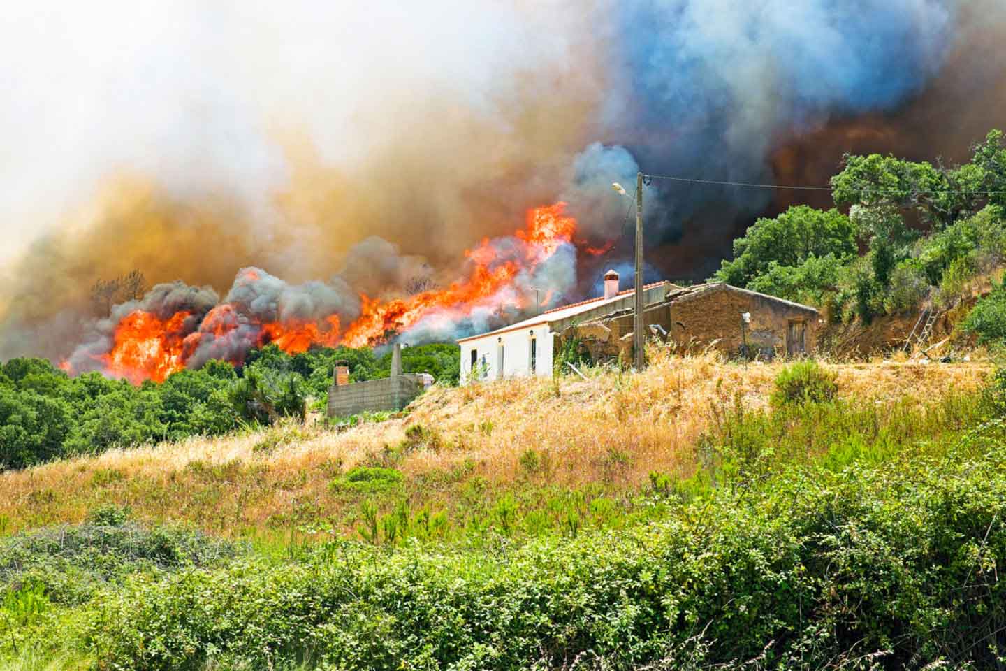 House on a hill caught in a wildfire