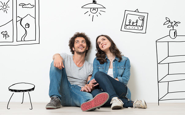 couple sitting on the floor thinking about buying a house