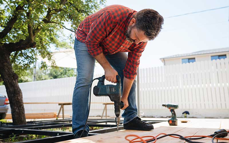 Man installing backyard deck
