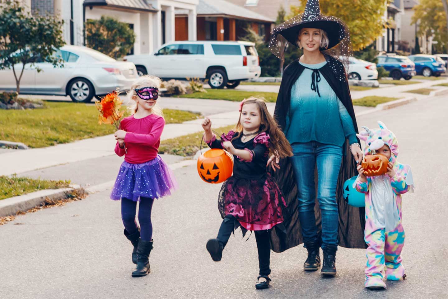 Mother with children going to trick or treat on Halloween holiday
