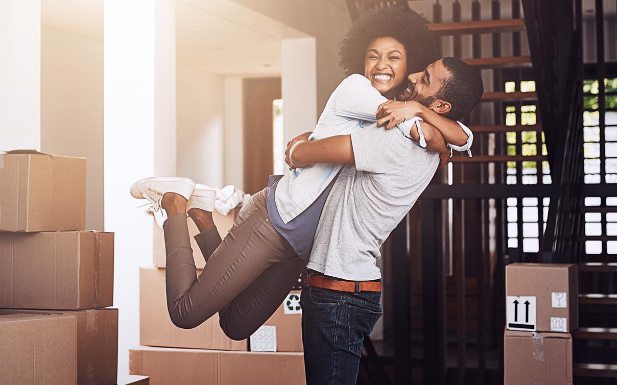 Happy couple hugging in new home
