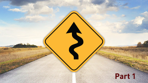 photograph of a winding road sign