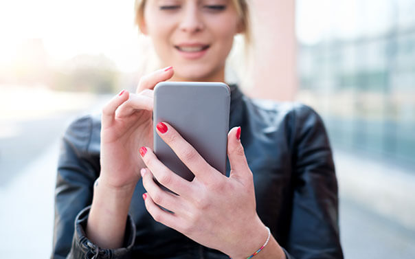Teen using an app on her smartphone