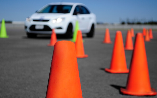 car on driving course with many cones