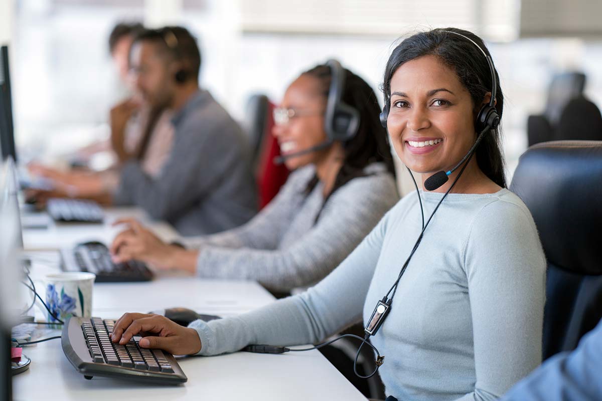 Smiling female operator working in call center