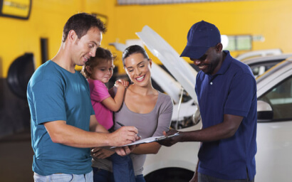 Family at authorized repair facility to get car fixed
