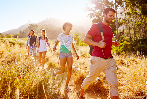 Young people hiking along mountain trail