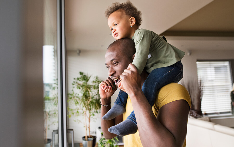 Homeowner with child on shoulders