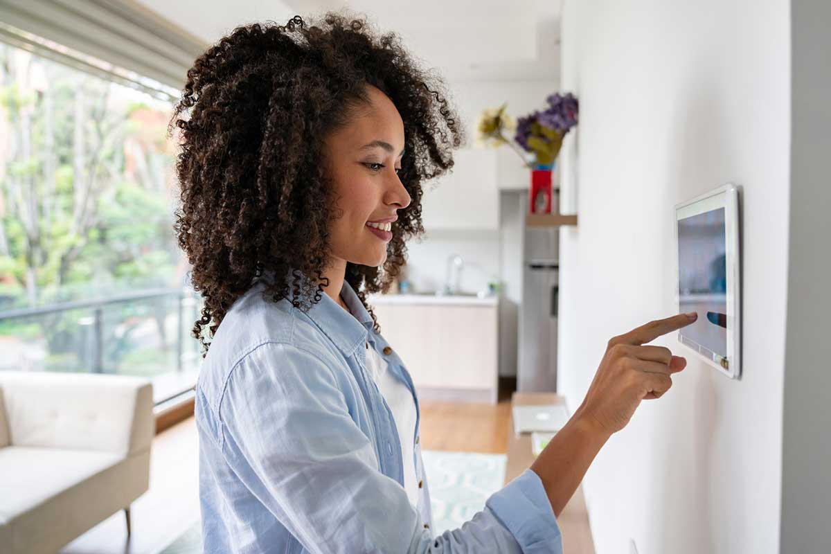 Young woman inputing settings on an intelligent home security system