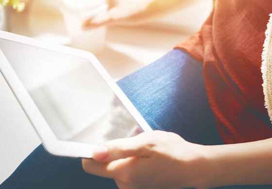 Woman reading news articles on a tablet