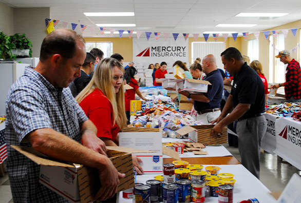 Mercury employees packing care packages for military servicemen