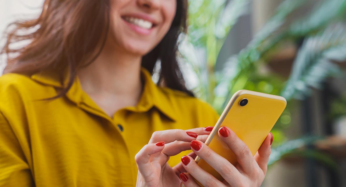 Woman using smartphone while at home