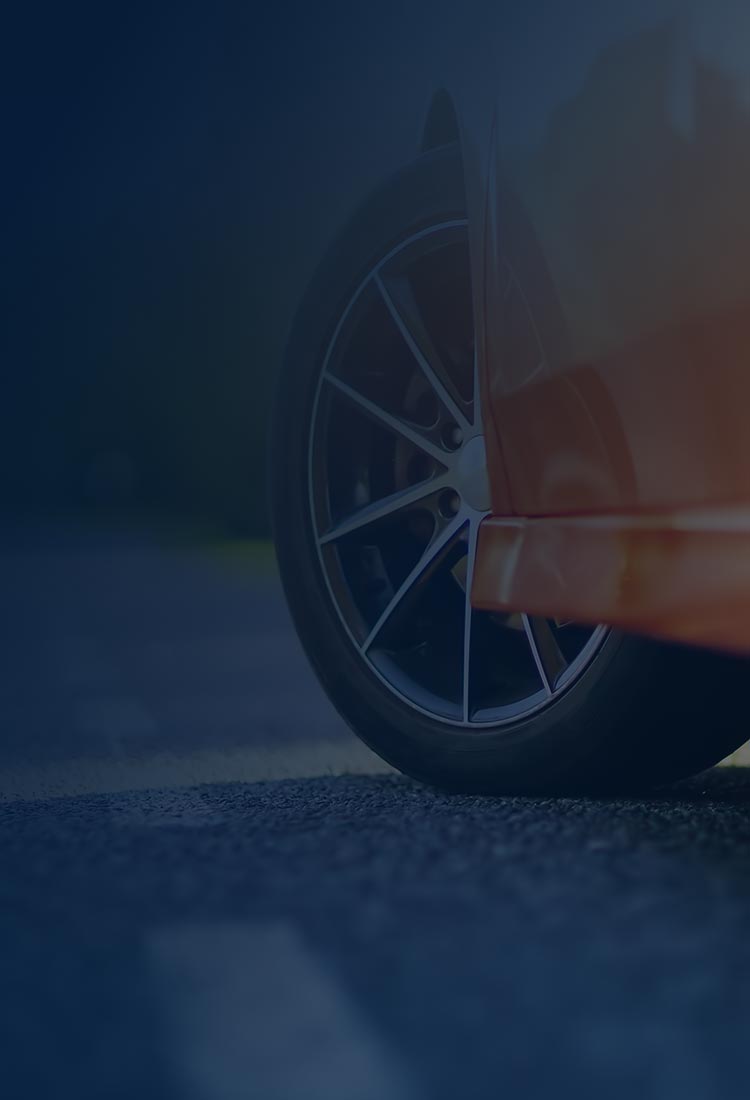 Close-up of red car on road