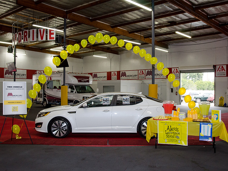 kia optima next to Alex's lemonade stand